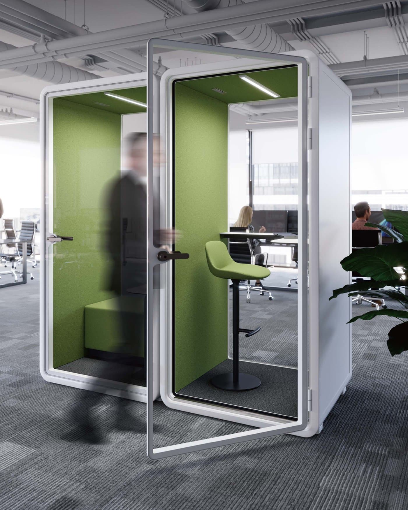 A single-person acoustic phone booth with an open door in an open-plan office